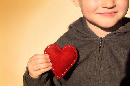 40083678 red heart in child hands kindness concept gift hand made valentine close up horizontal copy space